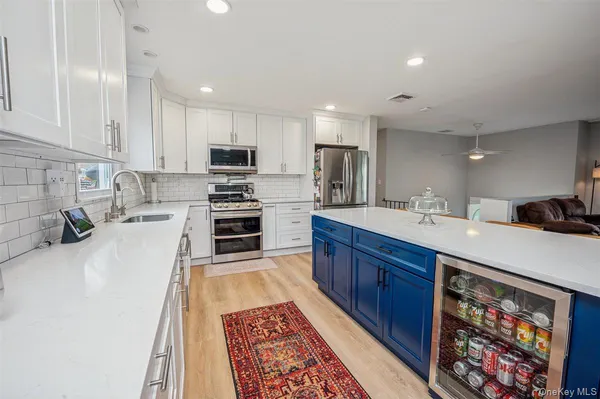 a kitchen with stainless steel appliances granite countertop a sink stove and cabinets