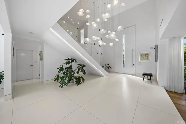 a very nice looking room with a large mirror and chandelier