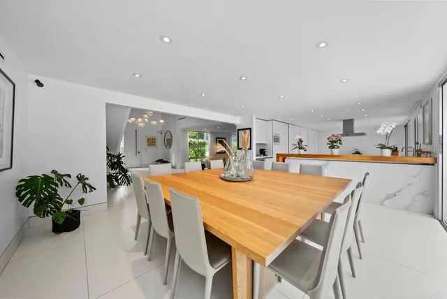 a dining room with furniture and a potted plant