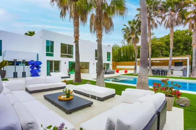 a view of an outdoor dining space with swimming pool
