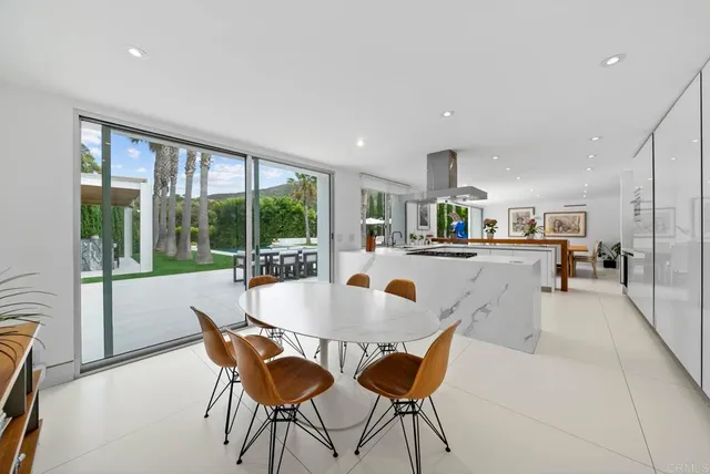 a dining room with furniture and a floor to ceiling window