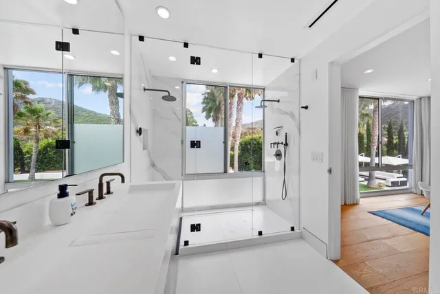 a bathroom with a tub shower and sink