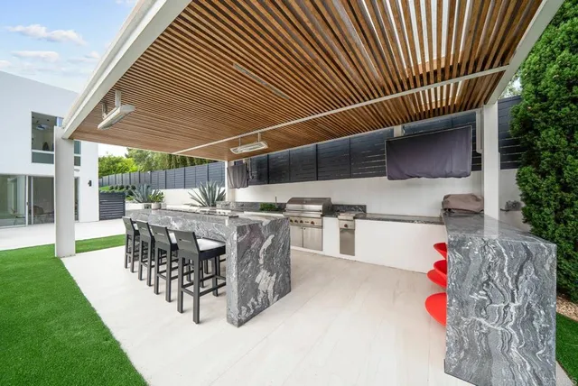 a view of a patio with a table and chairs