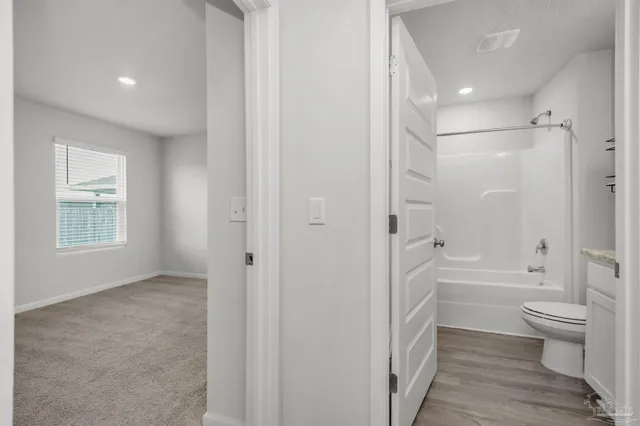 a bathroom with a bathtub toilet and a shower