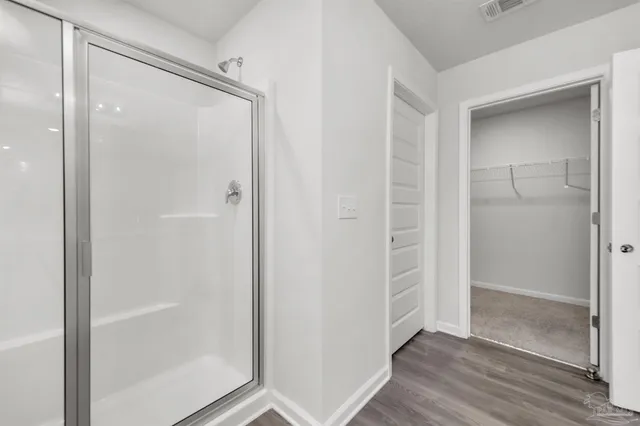 a bathroom with a glass shower door