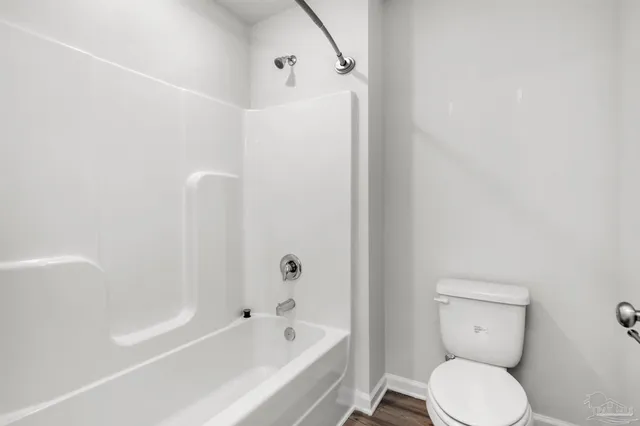 a bathroom with a toilet and bathtub