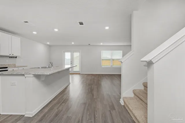 a view of kitchen with wooden floor and electronic appliances