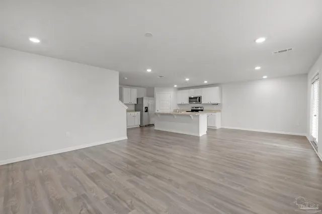 a view of kitchen with a sink wooden floor and kitchen