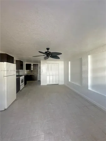 a view of a kitchen with a sink dishwasher and a refrigerator