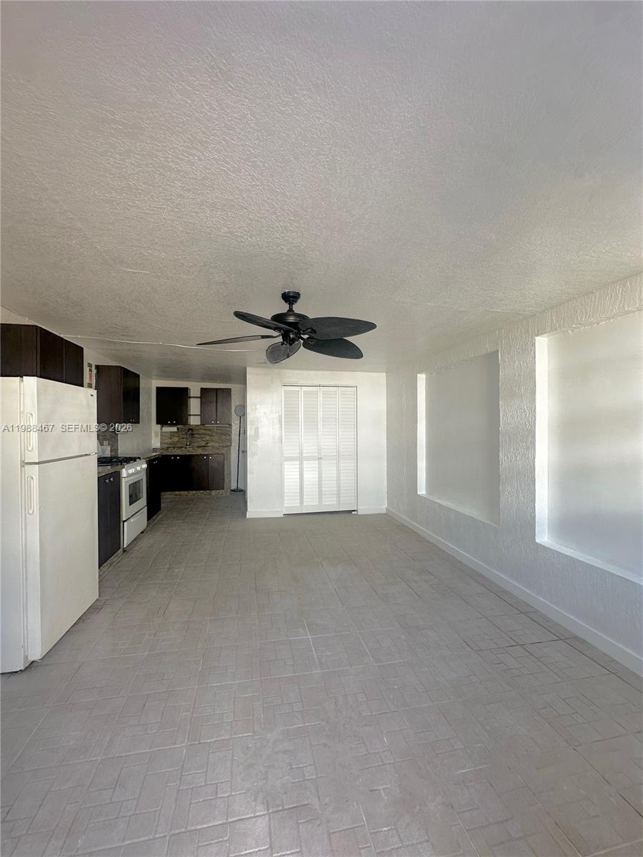 2753 West 68th Place, Unit 1 Hialeah, FL 33016 - Photo 5 of 13 a view of a kitchen with a sink dishwasher and a refrigerator