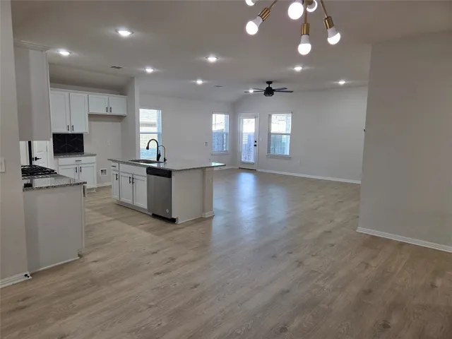 a view of a kitchen with stove and cabinets