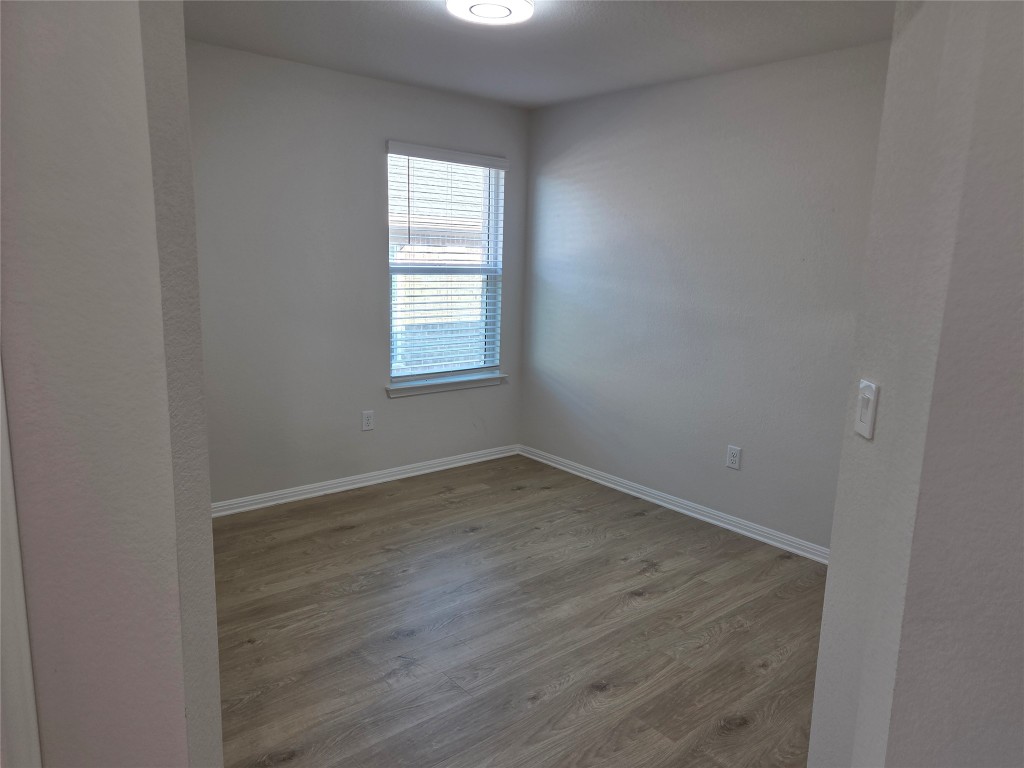 2421 Corriente Path Leander, TX 78641 - Photo 14 of 19 an empty room with wooden floor and windows