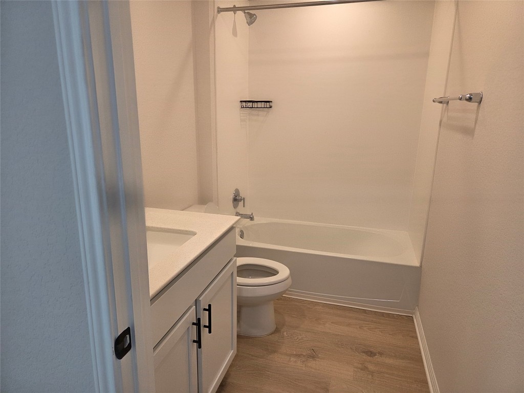 2421 Corriente Path Leander, TX 78641 - Photo 16 of 19 a bathroom with a granite countertop sink a toilet and shower