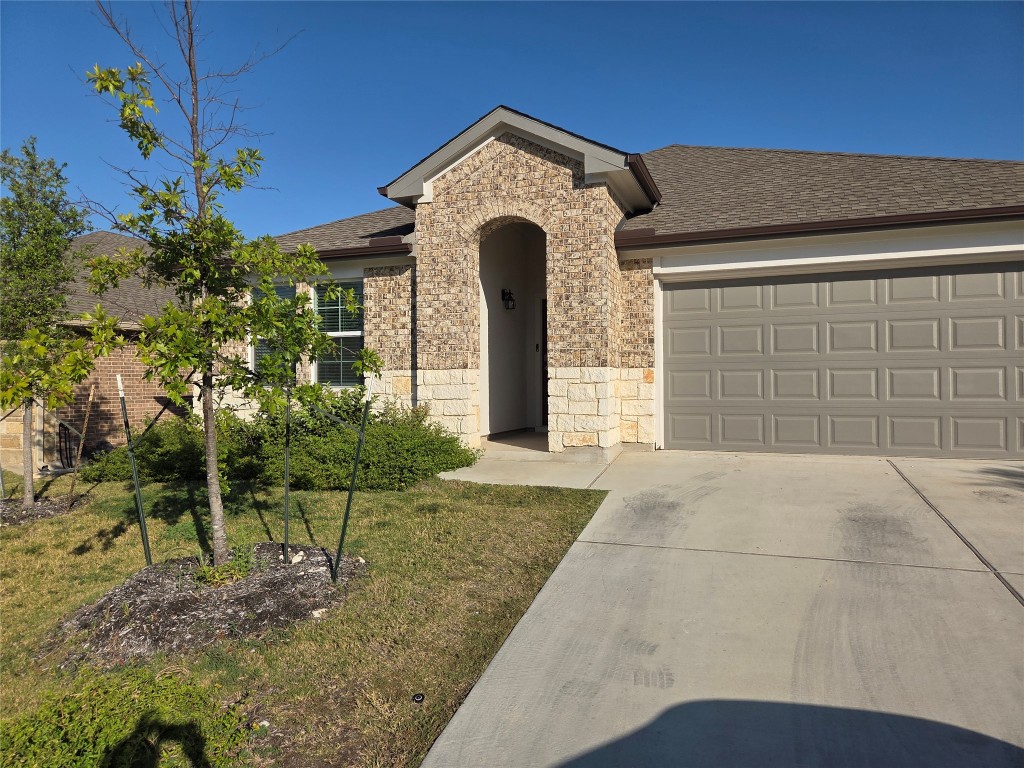 2421 Corriente Path Leander, TX 78641 - Photo 17 of 19 a front view of a house with garden