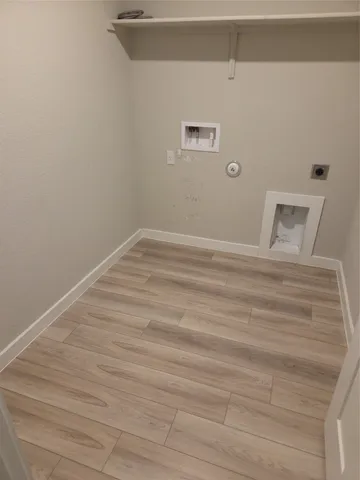 a view of a room with wooden floor