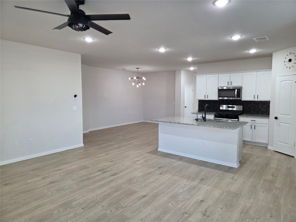 2421 Corriente Path Leander, TX 78641 - Photo 4 of 19 a view of kitchen with microwave and cabinets