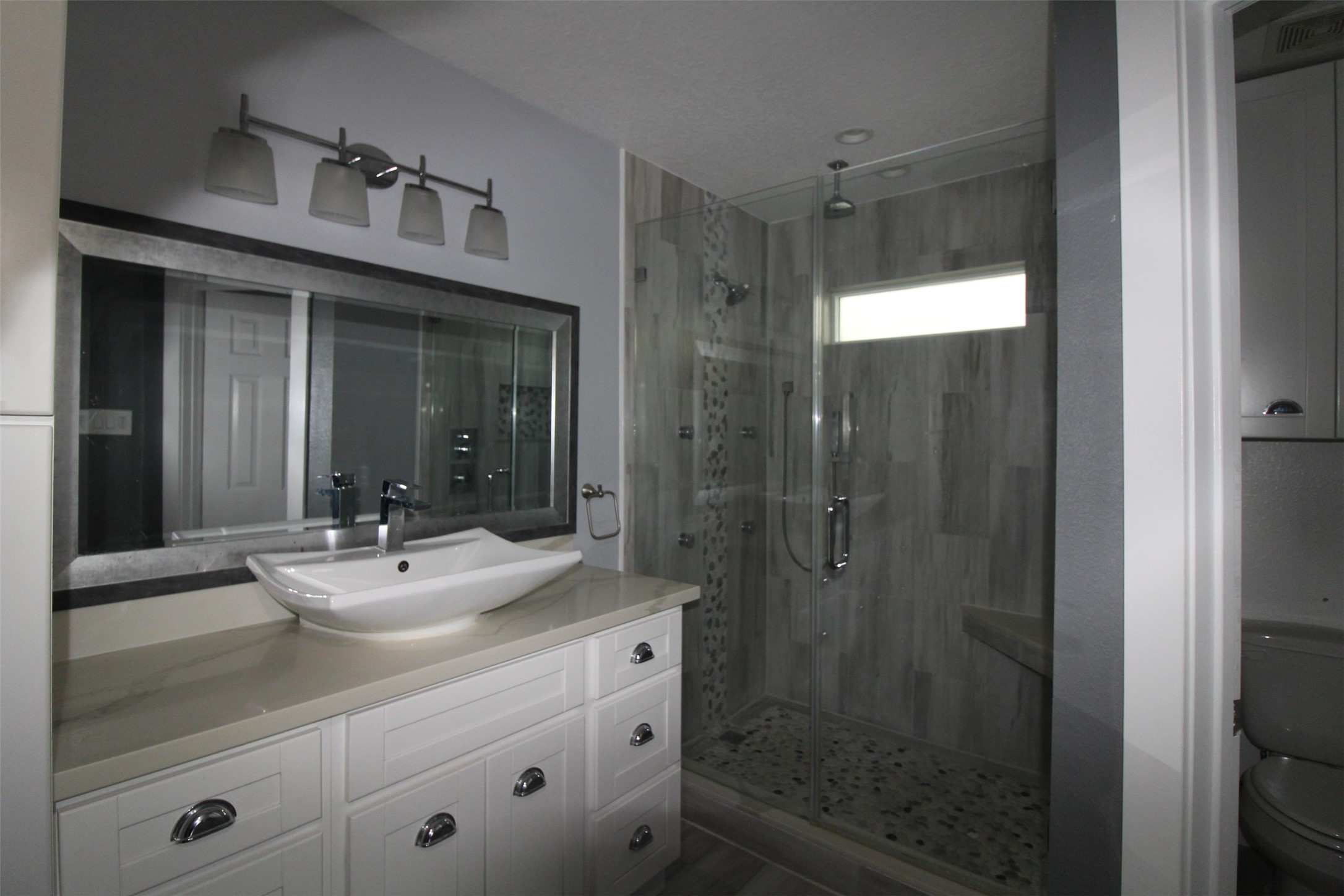 19614 Oleander Ridge Way Cypress, TX 77433 - Photo 12 of 13 a bathroom with a shower sink and mirror