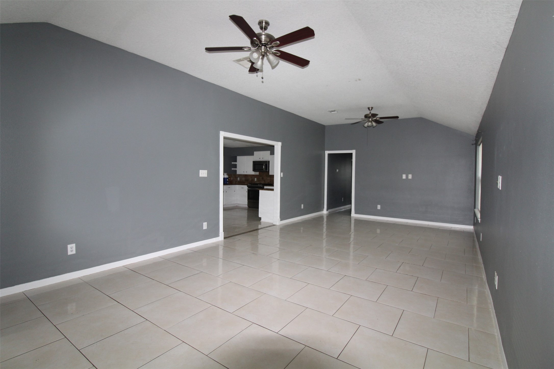 19614 Oleander Ridge Way Cypress, TX 77433 - Photo 4 of 13 wooden floor in an empty room with a chandelier fan