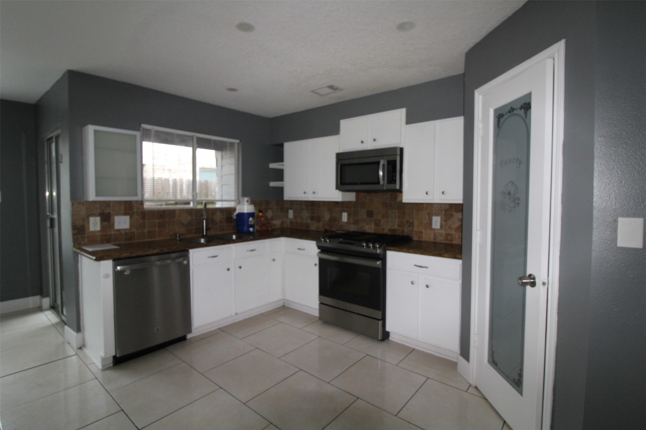 19614 Oleander Ridge Way Cypress, TX 77433 - Photo 7 of 13 a kitchen with a sink stove and microwave