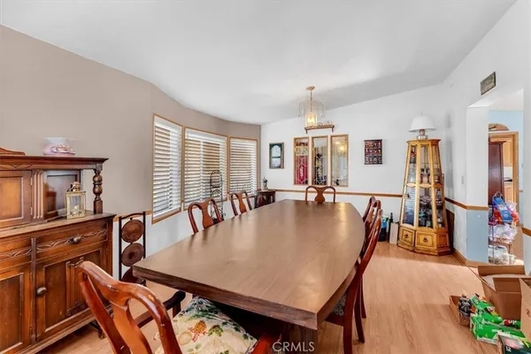 a bedroom with a bed and a large mirror on the dresser