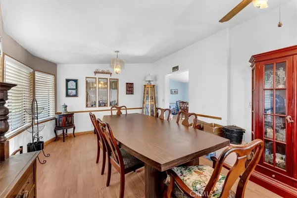 a bed sitting in a spacious bedroom next to a window