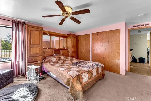 a bedroom with a bed and a book shelf
