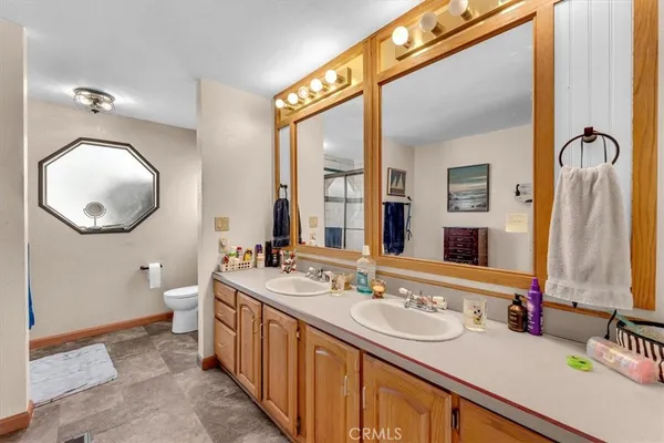 a bathroom with a sink a toilet and shower curtain