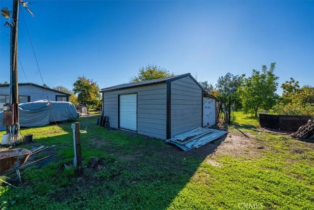 a view of a house with a yard and a garden