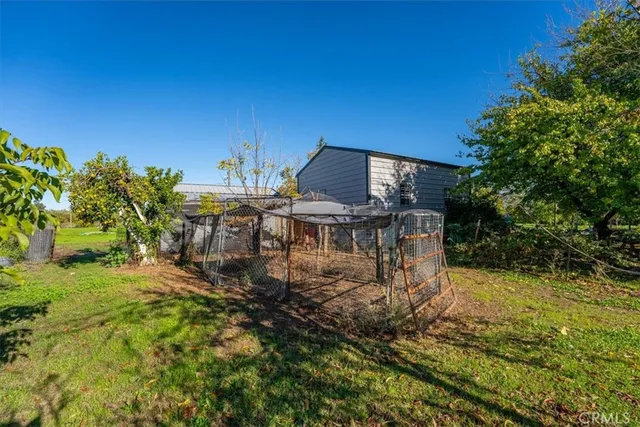 a view of a house with backyard and sitting area