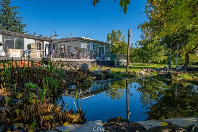 a view of backyard with swimming pool and seating space
