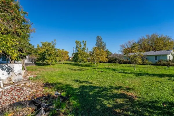 a backyard of a house with a yard and outdoor seating