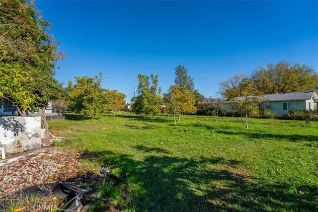 a backyard of a house with a yard and outdoor seating