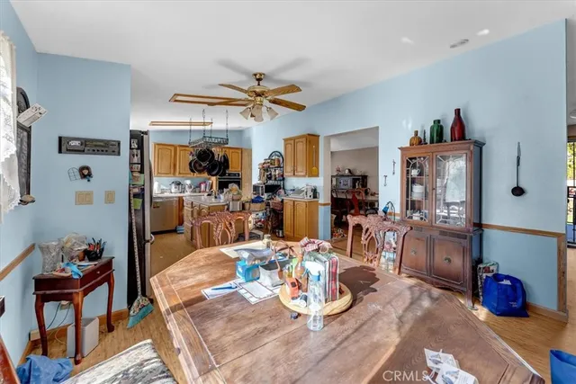 a view of a dining room and livingroom with furniture wooden floor a chandelier