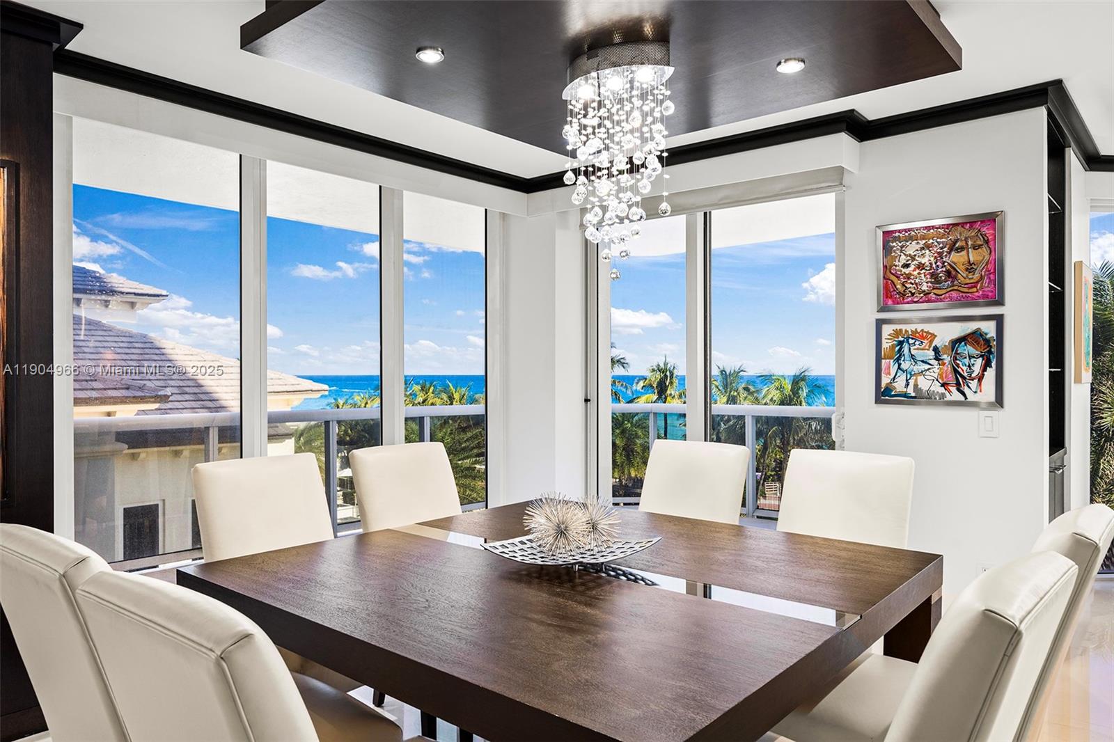 4775 Collins Avenue, Unit 501 Miami Beach, FL 33140 - Photo 17 of 60 a view of a dining room with furniture wooden floor and chandelier