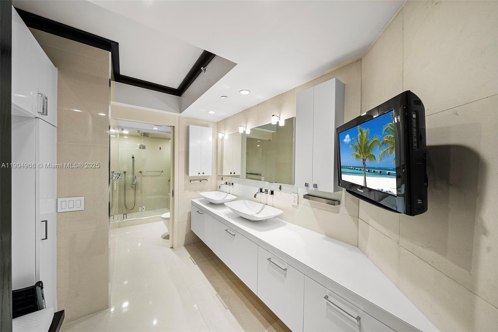 4775 Collins Avenue, Unit 501 Miami Beach, FL 33140 - Photo 21 of 60 a bathroom with a double vanity sink mirror and double