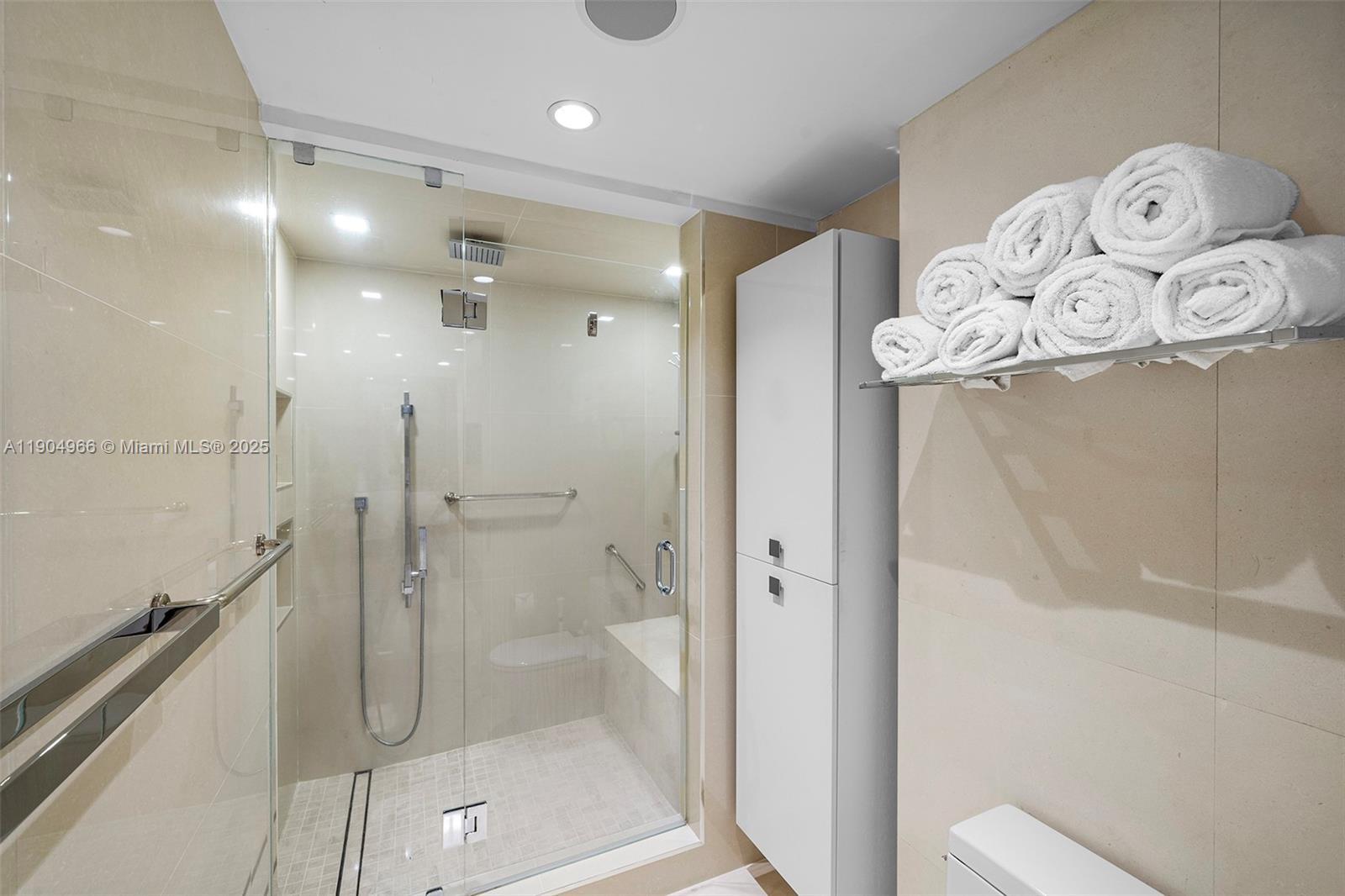 4775 Collins Avenue, Unit 501 Miami Beach, FL 33140 - Photo 22 of 60 a bathroom with a glass shower door