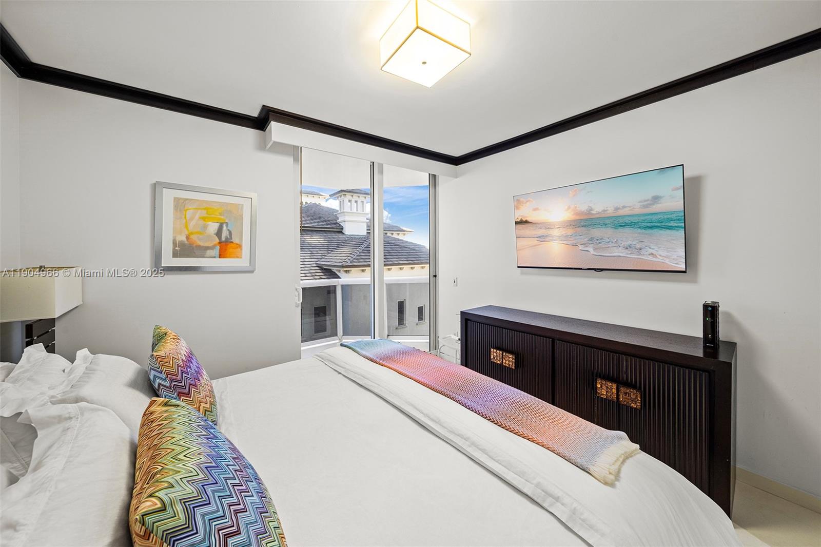 4775 Collins Avenue, Unit 501 Miami Beach, FL 33140 - Photo 24 of 60 a bedroom with a bed and a dresser next to a window