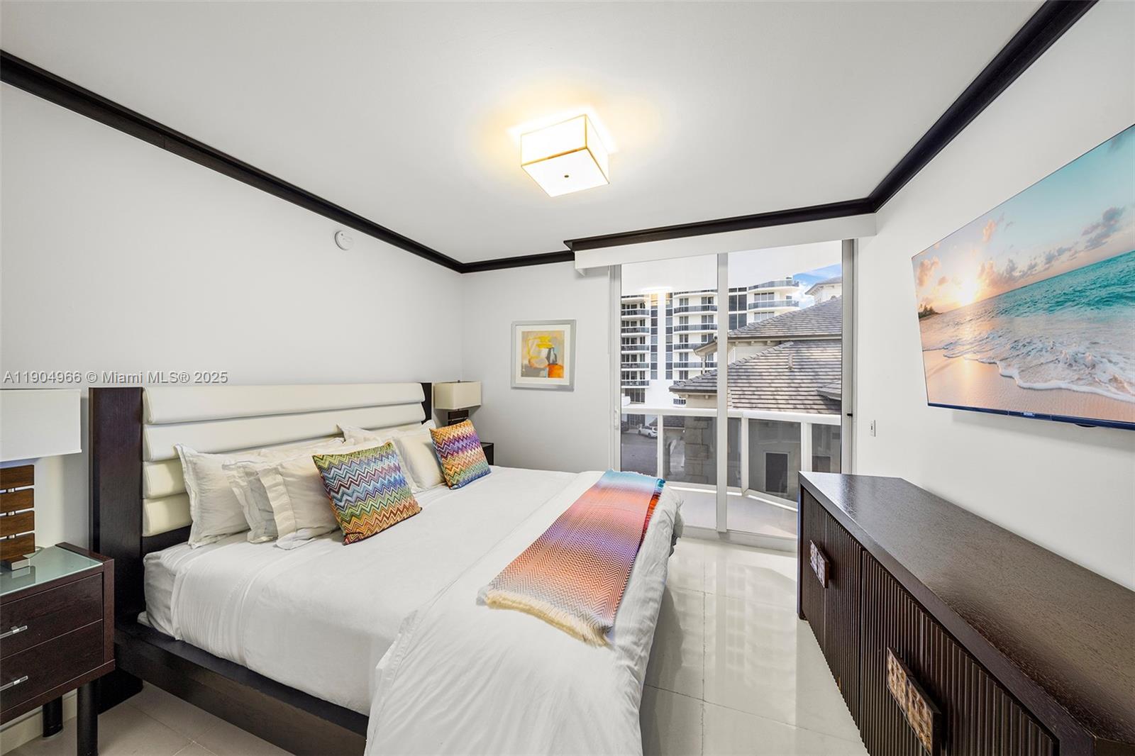 4775 Collins Avenue, Unit 501 Miami Beach, FL 33140 - Photo 26 of 60 a large bedroom with a bed and wooden floor