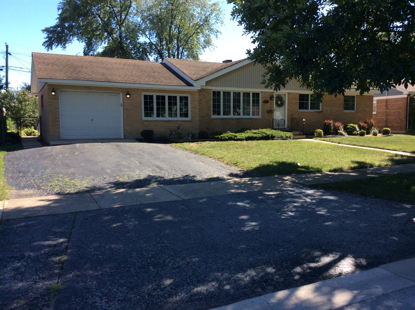 5909 107th Street Chicago Ridge, IL 60415 - Photo 1 of 32 a front view of a house with a yard and garage