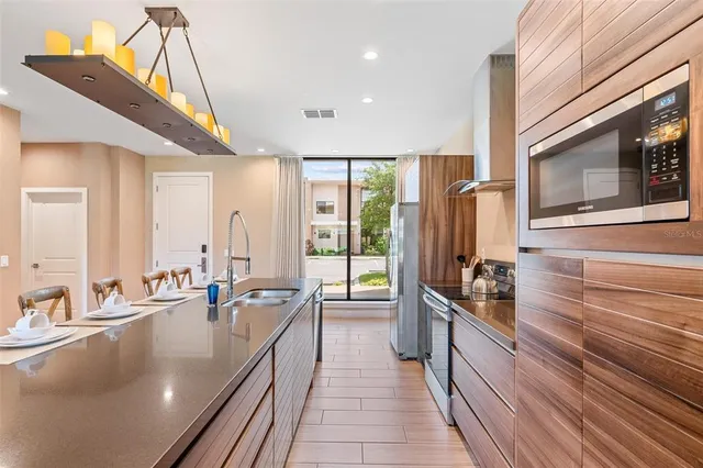 a very nice looking living room with a large window and stainless steel appliances