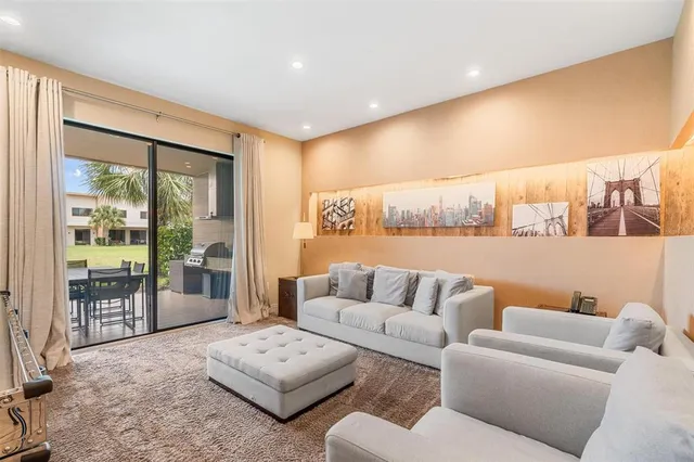 a living room with furniture and large windows