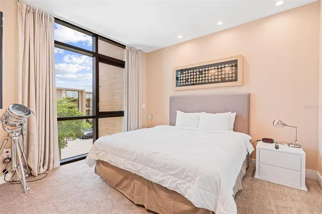 a bedroom with a bed a couch and a window