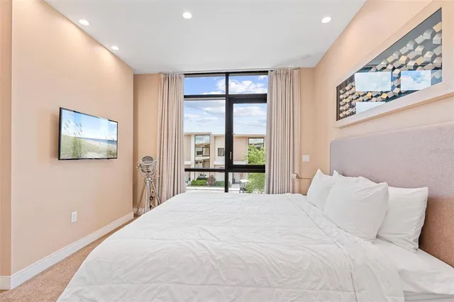 a bedroom with a large bed and a window