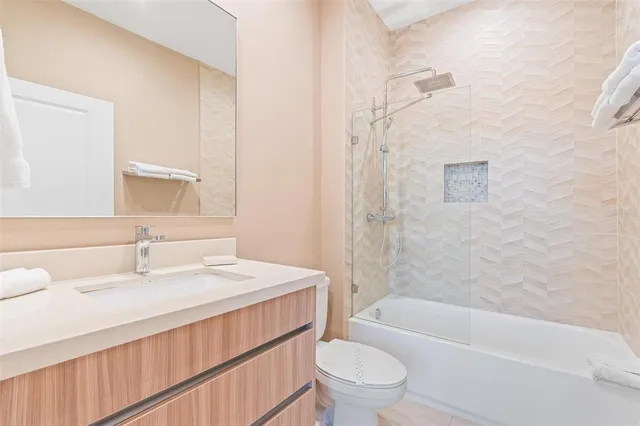 a bedroom with a large bed and a large window