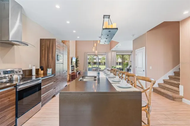 a kitchen with a large counter top appliances and wooden floor