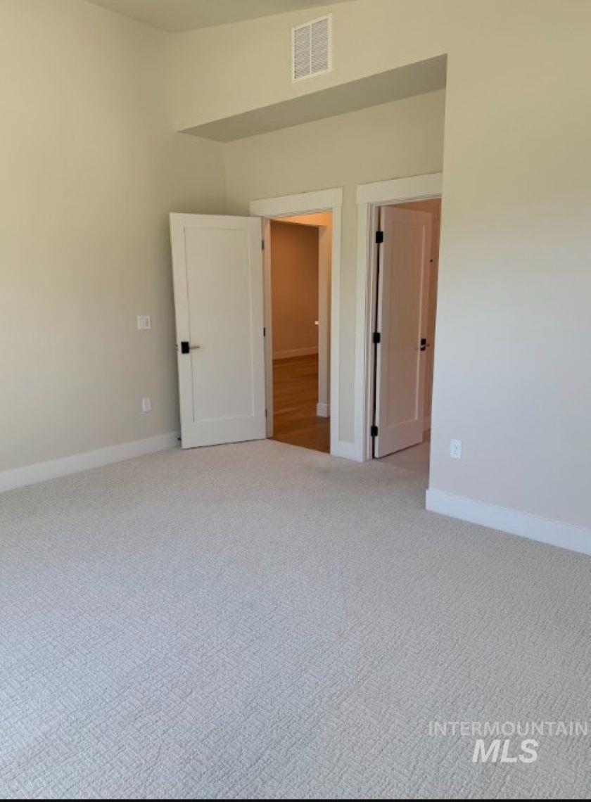 683 West Wrangler Street Meridian, ID 83646 - Photo 11 of 23 Neutral tone walls with white trim and carpeting