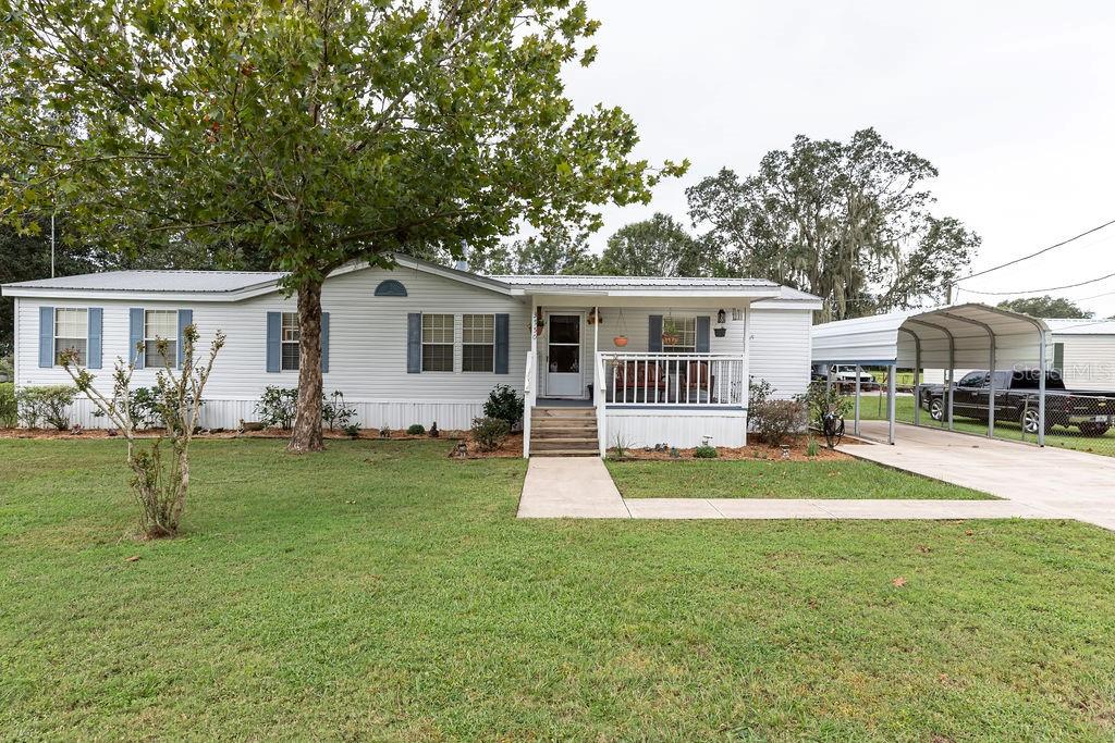 a front view of house with yard and green space