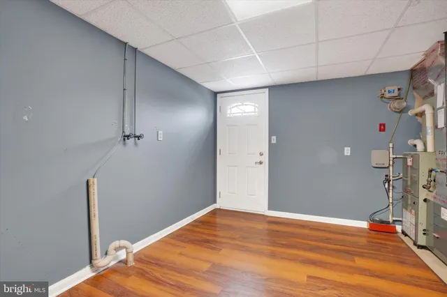 a big room with wooden floor and windows