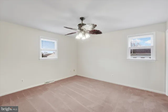 a view of a room with a chandelier fan and closet
