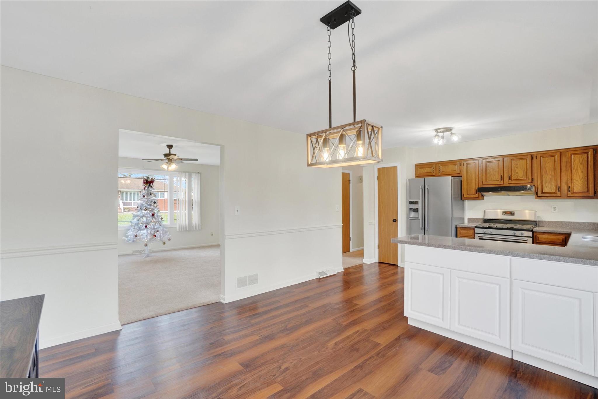 11 Dogwood Lane Manchester, PA 17345 - Photo 8 of 23 a view of a kitchen with stainless steel appliances granite countertop a stove a refrigerator a sink dishwasher with wooden floor and cabinets